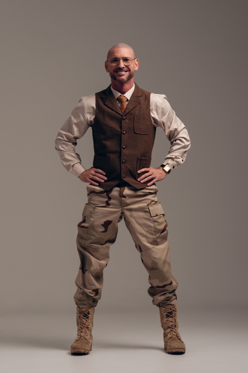 Todd Kane in the integrated uniform — vest and tie on top, camo pants and combat boots below