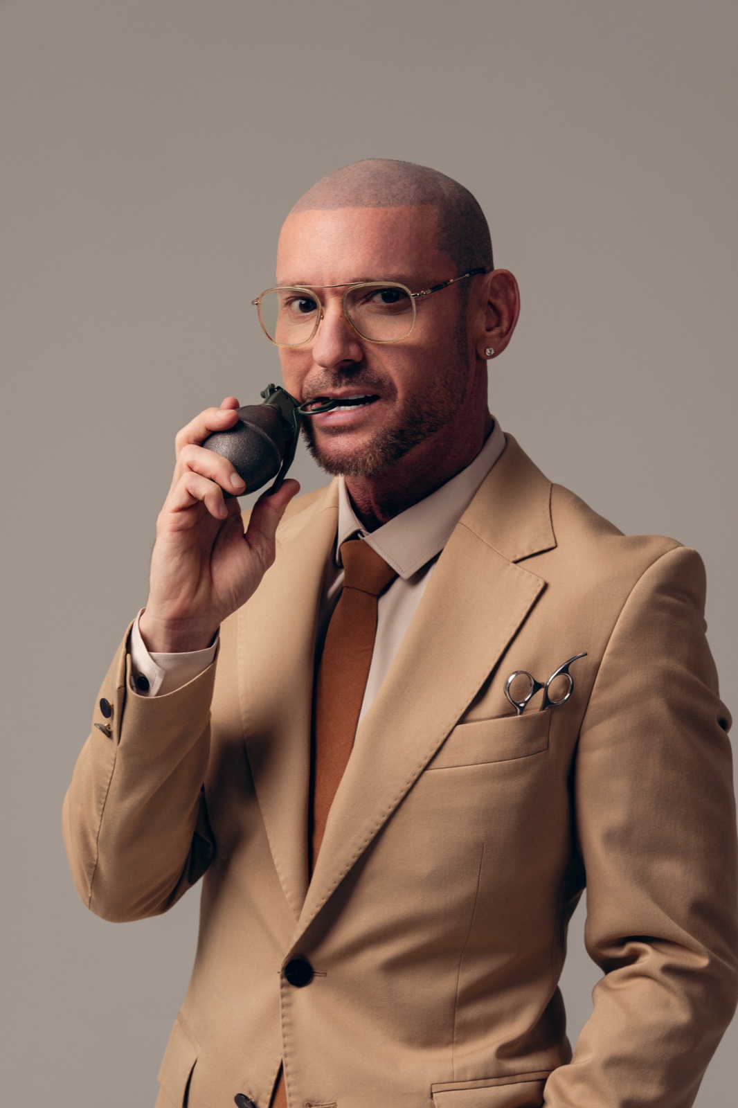 Todd holding a grenade like a radio — commanding presence